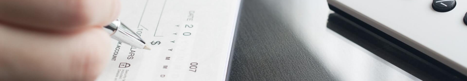 a person writing a business check